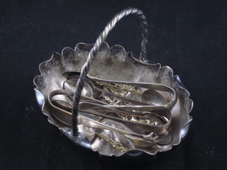 An oval silver plated bowl and a collection of various spoons and tongs