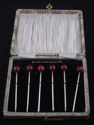 A set of 6 silver cocktail sticks, cased