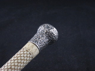 A carved ivory walking cane with silver mount