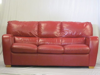A 3 seat settee upholstered in red leather 72"
