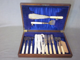 A set of 6 silver plated fish knives and forks, complete with  servers, 1 fork missing, contained in an oak canteen box