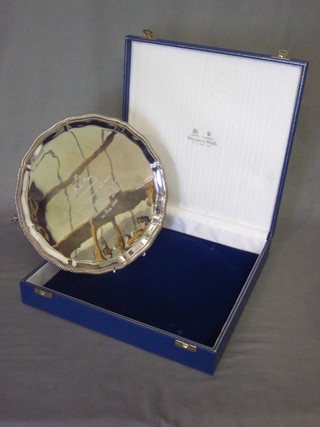 A modern silver salver with bracketed border, raised on 3 ball  and claw feet, 19ozs, engraved