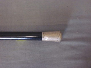 An ebony walking cane with silver handle