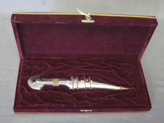 An Eastern dagger contained in a white metal and jewel studded case 9 1/2"
