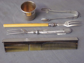 A comb with silver mount, a silver fork, pair of silver tongs etc