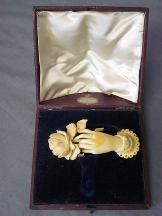A Victorian carved ivory in the form of a hand clasping a rose 3  1/2"