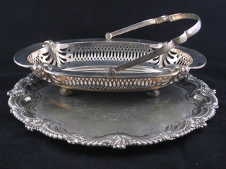 An oval pierced silver plated boat shaped cake basket with swing handle 11" and a section of silver plated salver 12"