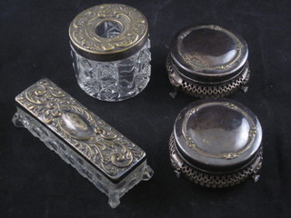A pair of circular silver plated dressing table jars with blue glass  liners, a silver plated hair tidy and a rectangular pin jar and cover
