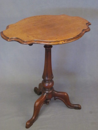 A Victorian shaped mahogany snap top wine table, raised on a turned and fluted tripod base 25"