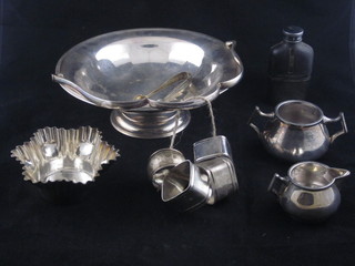 A silver plated cake basket with swing handle, 4 napkin rings and  other plated items