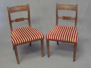 A set of 6 Georgian bleached mahogany bar back dining chairs  with shaped mid rails and upholstered seats, raised on turned  supports, some old worm,