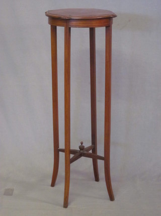 An Edwardian circular inlaid mahogany jardiniere stand raised on  tapering supports with X framed stretcher 14"