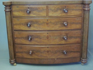 A Victorian mahogany bow front chest of 2 short and 3 long  drawers with tore handles and chamfered columns to the sides,  53"
