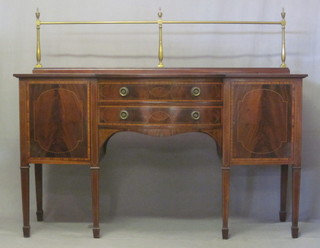 An Edwardian bow front inlaid mahogany sideboard with brass railed back, fitted 2 long drawers above a pair of cupboards,  raised on square tapering supports ending in spade feet 66"   ILLUSTRATED