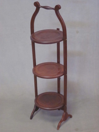 An Edwardian circular inlaid mahogany 3 tier folding cake stand