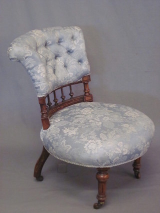 A Victorian walnut show frame nursing chair with bobbin turned decoration and upholstered seat and back, raised on turned and  fluted supports