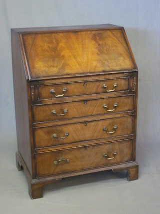 A Georgian style mahogany bureau, the fall front revealing a well fitted interior above 4 long drawers, raised on bracket feet  29"