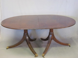 A Georgian style mahogany D end extending dining table, raised  on pillar and tripod supports with 1 extra leaf