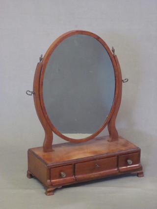 A 19th Century mahogany oval plate dressing table mirror, raised  on a rectangular base and fitted 1 long and 2 short drawers,  raised on bracket feet 16"
