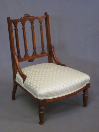 A Victorian inlaid mahogany stick and rail back nursing chair  with upholstered seat, raised on turned supports