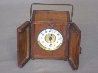 A 19th Century travelling clock with 2" circular porcelain dial contained in a walnut case