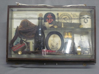A hanging display cabinet containing various reproduction naval  effects