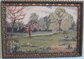 A Berlin wool work panel depicting a country garden 13" x 20" contained in a gilt frame