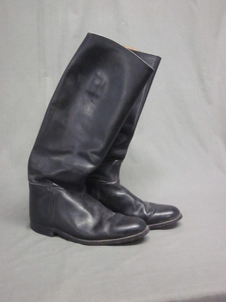 A pair of black leather riding boots, size 9