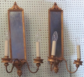A pair of 19th/20th Century rectangular plate mirrors, the base incorporating 2 candle sconces, converted for electricity