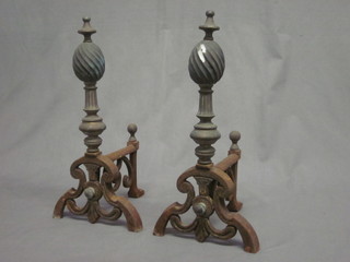 A pair of Victorian wrought iron and brass fire dogs
