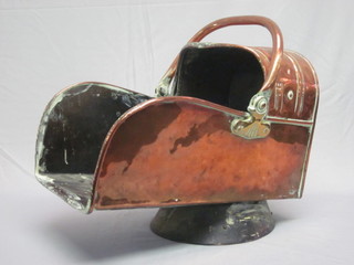 A copper Art Nouveau helmet shaped coal scuttle