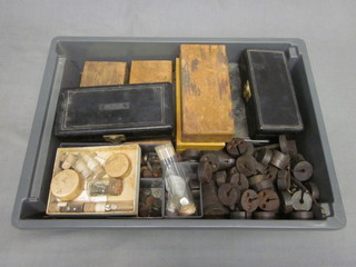A plastic tray containing a collection of weights