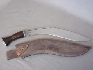 A Kukri, the 12" blade marked BM complete with leather  scabbard