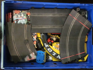A blue plastic crate containing various Scalectrix track etc