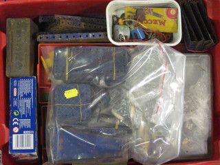 A red plastic crate containing items of Meccano