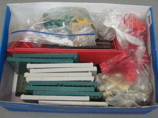 A shoe box containing a collection of plastic building blocks