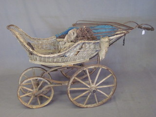 A 19th Century Continental 4 wheeled perambulator with iron shod wheels and basket work body  ILLUSTRATED
