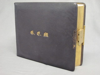 A Victorian leather bound family photograph album complete  with plush carrying case