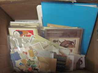 A box containing various stamp postcards etc