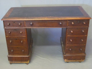 A Victorian mahogany kneehole pedestal desk with inset writing surface, fitted 1 long and 8 short drawers, 47"