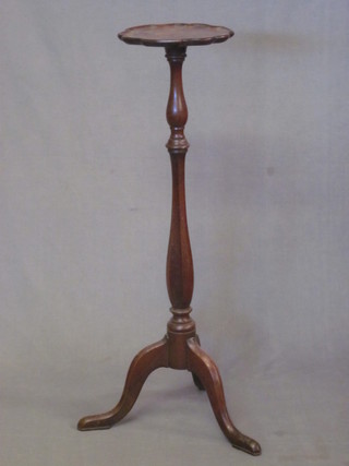 A 19th Century turned mahogany torchere with shaped top,  raised on a pillar and tripod base