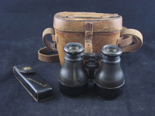 A pair of opera glasses contained in a leather carrying case and a Letherman folding plier/knife set