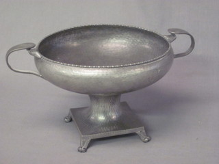 A Don planished pewter twin handled bowl raised on a spreading  foot 9"