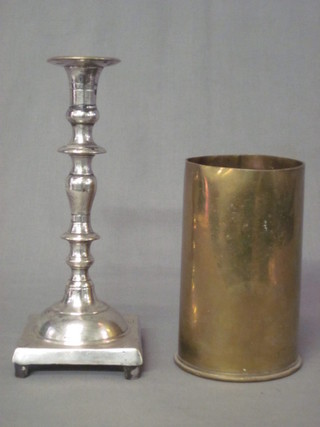 A 25lb shell case and a plated candlestick