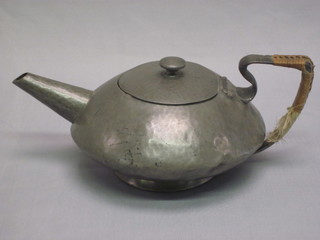 An Art Nouveau circular planished English pewter teapot, the  base marked 0483