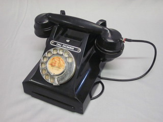 A Bakelite black dial telephone
