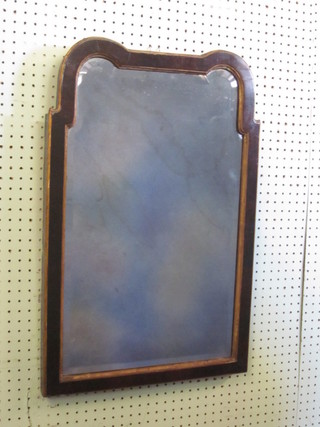 A Queen Anne style shaped bevelled plate mirror contained in a walnut frame 25"