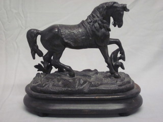 A 19th Century spelter figure of a walking horse, raised on a wooden base 10"