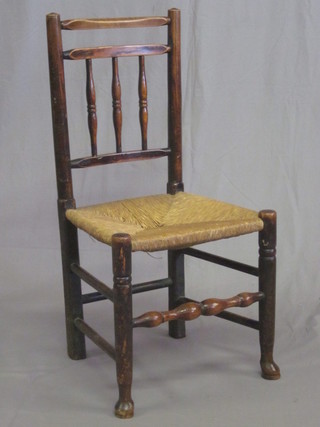 An elm stick and bar back chair with woven rush seat raised on club supports