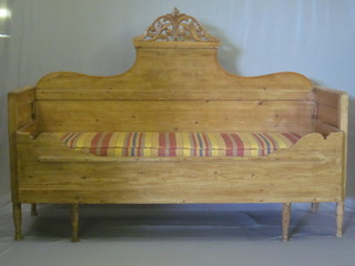 A Continental stripped and polished pine ottoman converting into a bed with raised back 71"